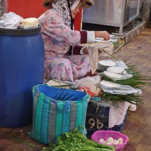 Lady selling vegetables in the traditional outfit of the northern Berbers